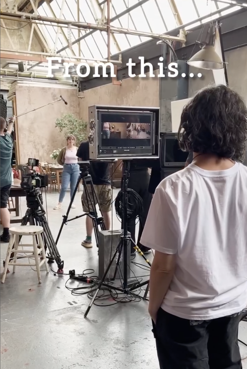 Four filmmakers on set in a large room.