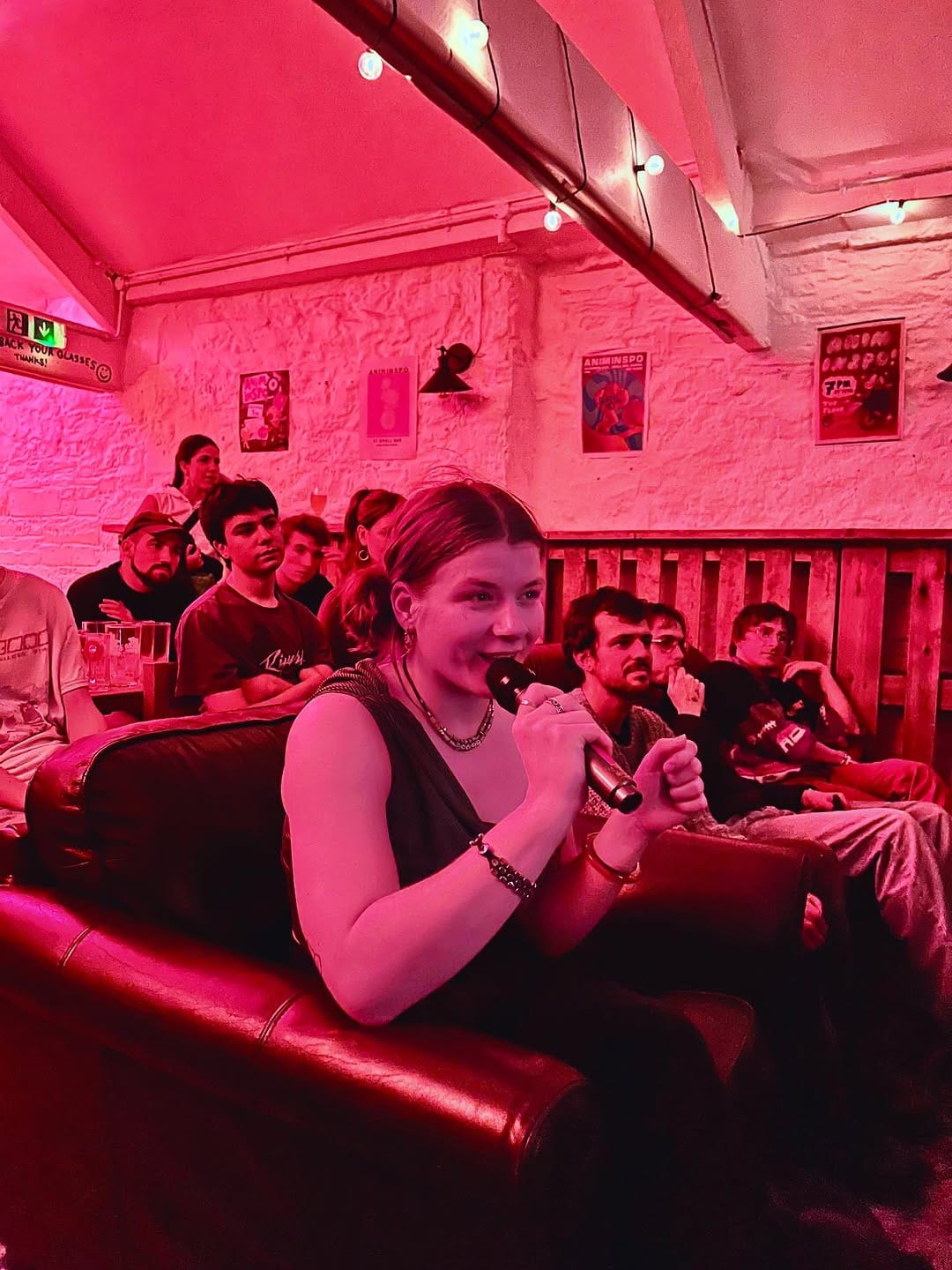 A filmmaker talks into a microphone at a screening.