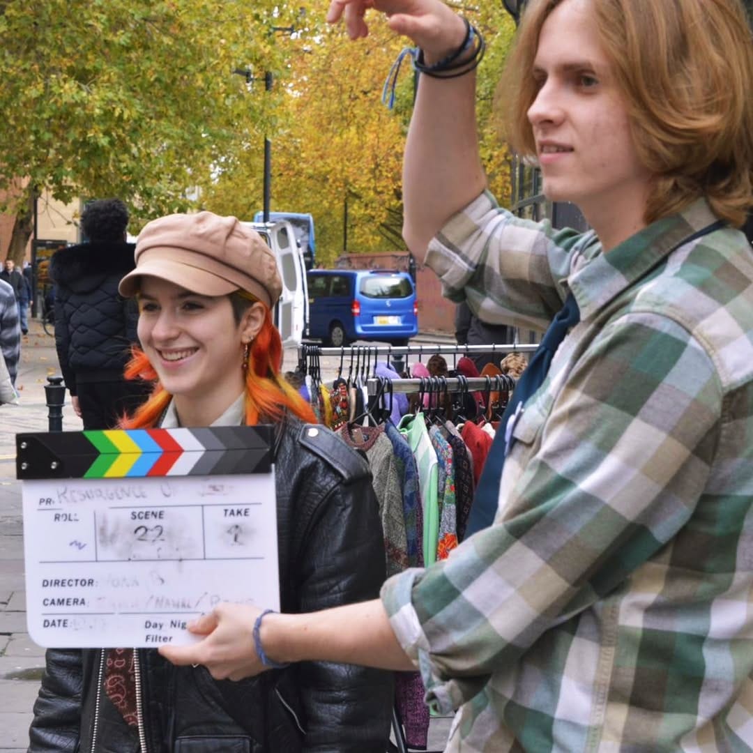 Two filmmakers with a clapper board on an exterior location