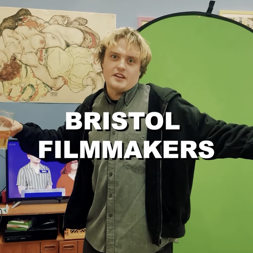 A person standing with a pint in front of a greensceen with the title 'BRISTOL FILMMAKERS' overlayed.