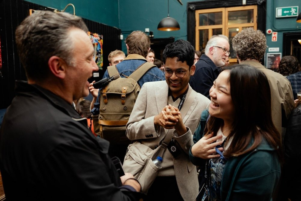 Three filmmakers chat at a mixer session